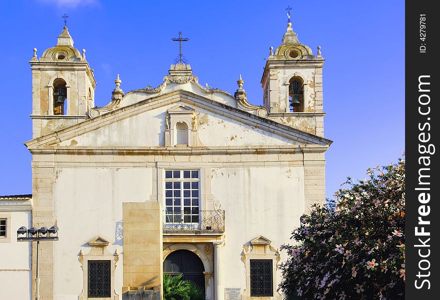 Portugal, area of Algarve, Lagos: Santo Antonio Church; area of Algarve, Albufeira: typical religious architecture. blue sky and detail of a white church. Portugal, area of Algarve, Lagos: Santo Antonio Church; area of Algarve, Albufeira: typical religious architecture. blue sky and detail of a white church