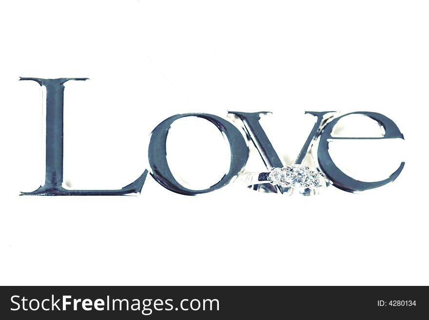 Word LOVE in silver metal on white with ring, isolated