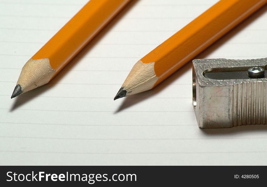 Image of two pencils with sharpener next to them - 1