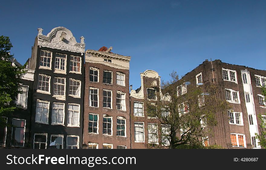 Amsterdam Buildings Reflected On A Canal.