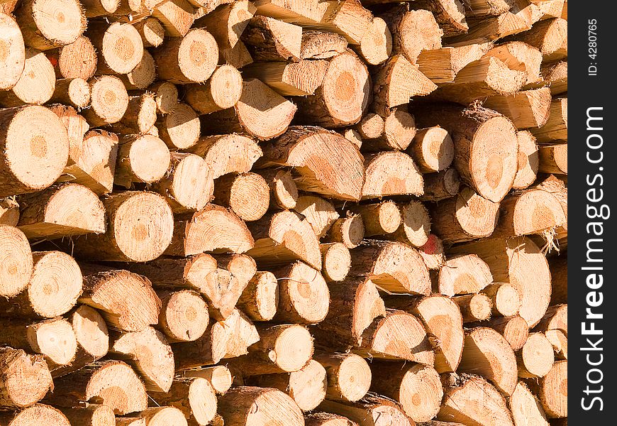 Pile of chopped firewood highlighted by the sun. Pile of chopped firewood highlighted by the sun