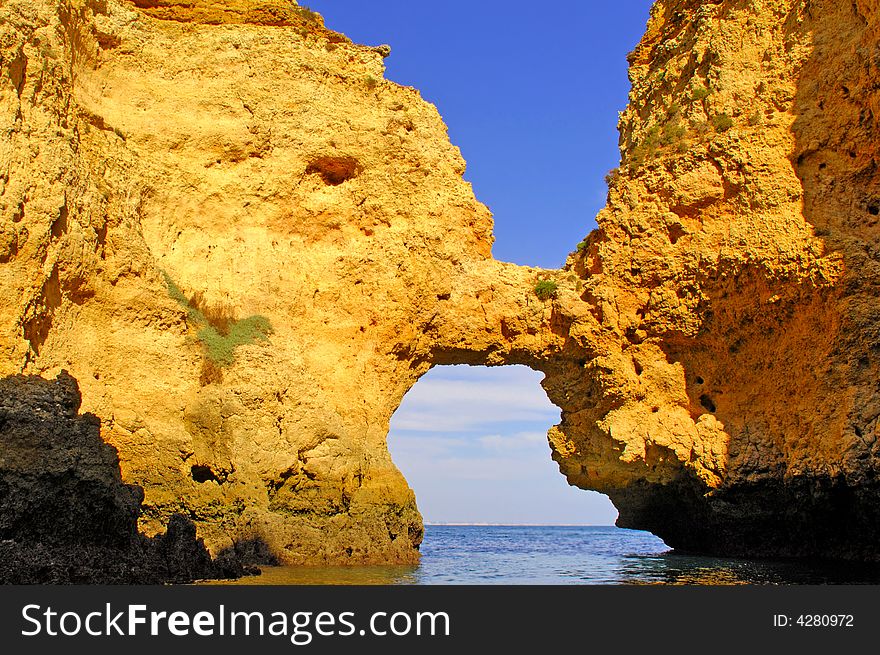 Portugal, area of Algarve: Sagres Wonderful coastline; blue sky, blue water and yellow stone coast. Portugal, area of Algarve: Sagres Wonderful coastline; blue sky, blue water and yellow stone coast