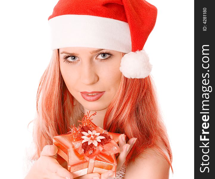 Winter portrait of a beautiful young red head woman holding a gift in her hands. Over white background. Winter portrait of a beautiful young red head woman holding a gift in her hands. Over white background