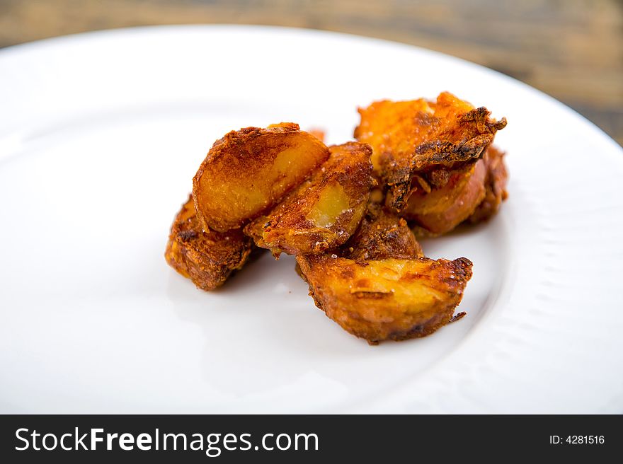 Roasted red potatoes on a white plate