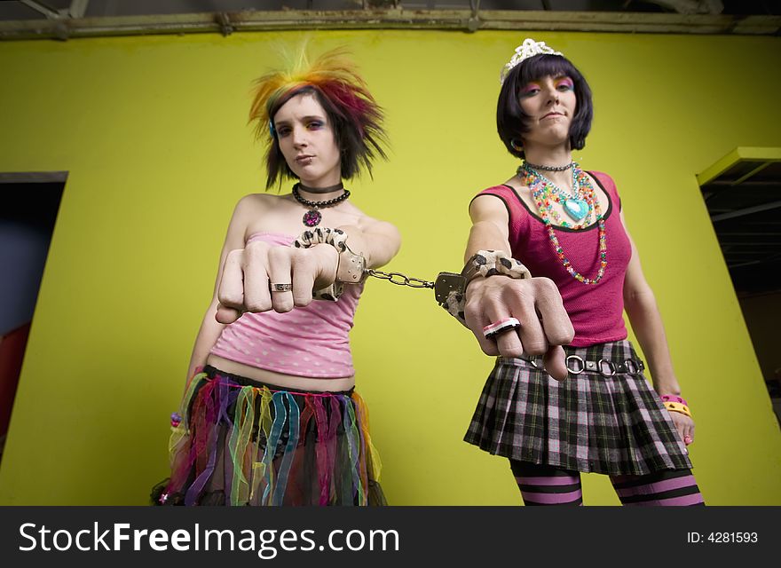 Young punk women linked by handcuffs