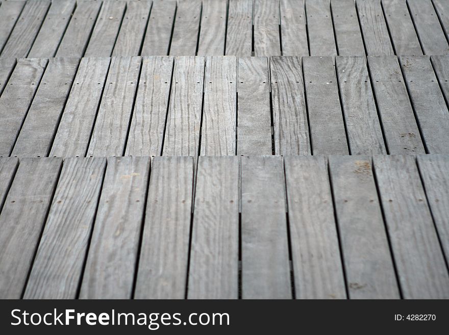 Wooden stairs on the sand of the beach. Closeup.