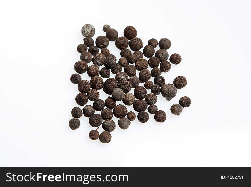 Allspice balls isolated against a white background