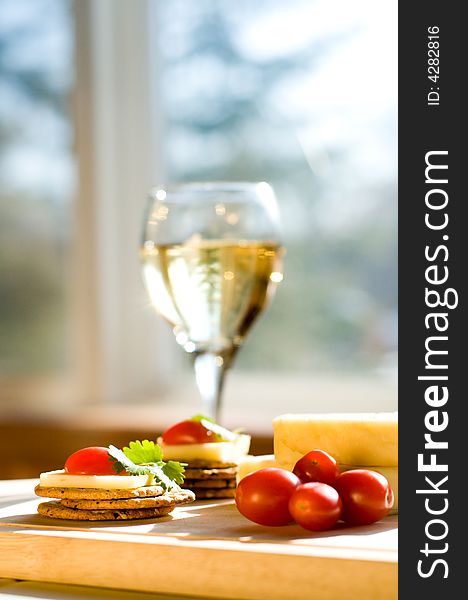 Cheese and crackers on a cutting board. Cheese and crackers on a cutting board