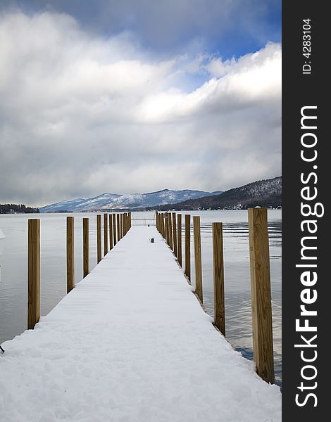 Snow covered pier near the lake in the majestic mountains. Snow covered pier near the lake in the majestic mountains