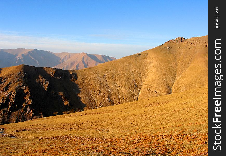 Mountains under sunlight. Babaytag region, Uzbekistan. Mountains under sunlight. Babaytag region, Uzbekistan