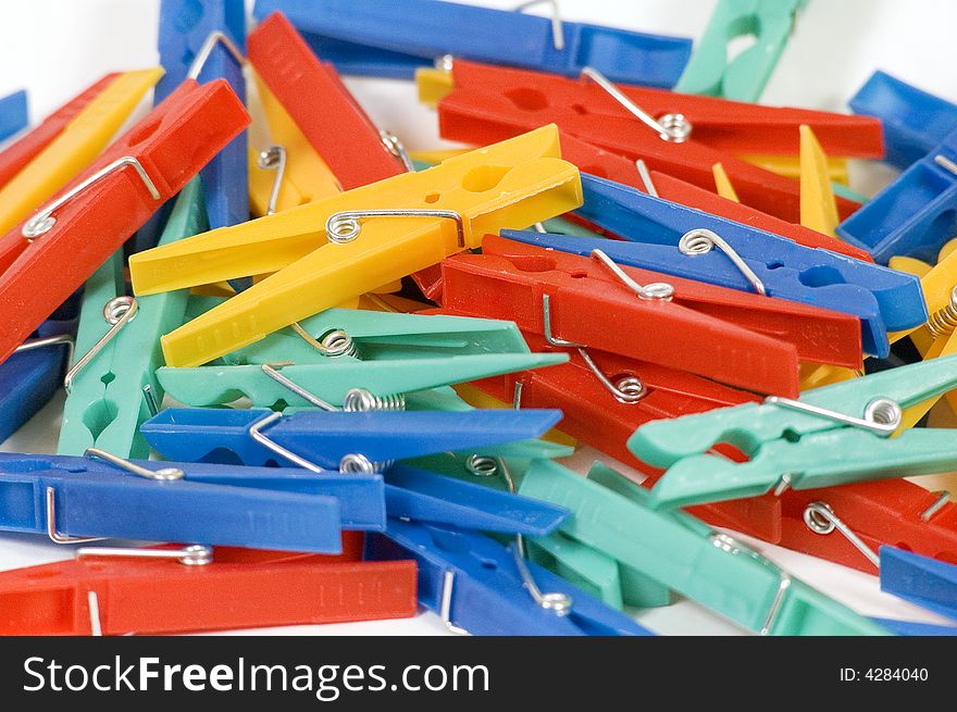 A pile of colorful cloths clips on a white background.