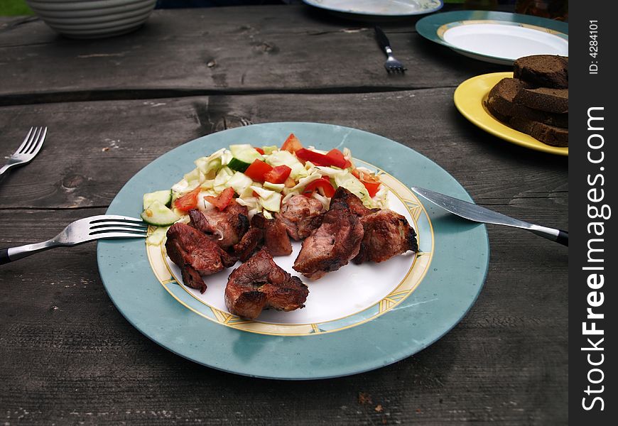 Grilled meat and fresh green salad