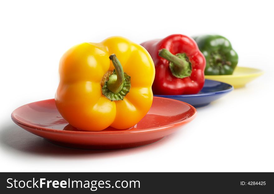 An image of color peppers on a saucers. An image of color peppers on a saucers