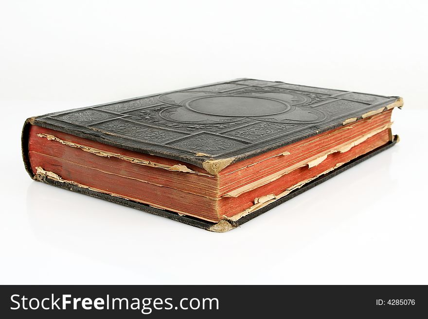 Single very old book in black cover over white background