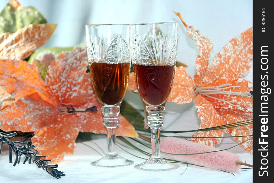 Two crystal glasses on a background of flowerses. Two crystal glasses on a background of flowerses