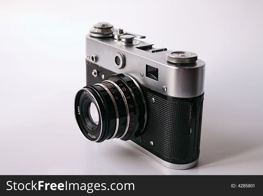 Old camera, black with brilliant details, isolated