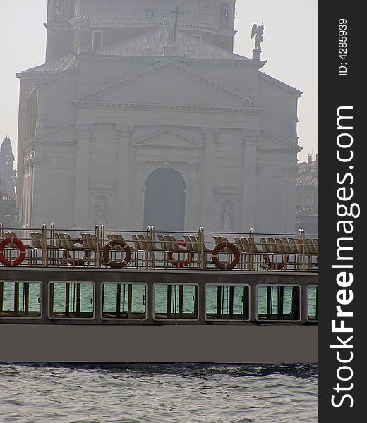 Empty vaporetto tourist boat in Venice passing in front of San Giorgio Maggiore church on the Giudecca Canal. Empty vaporetto tourist boat in Venice passing in front of San Giorgio Maggiore church on the Giudecca Canal