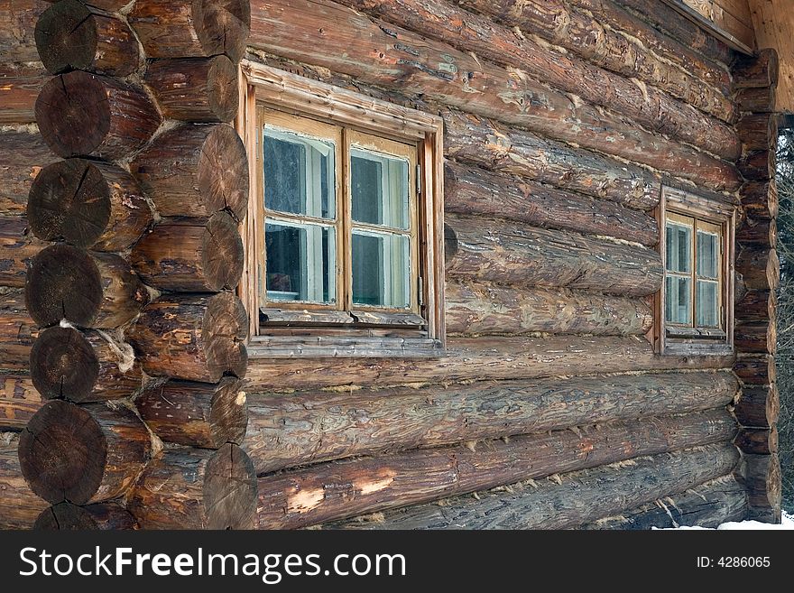 Logs in the wall of old rural house.