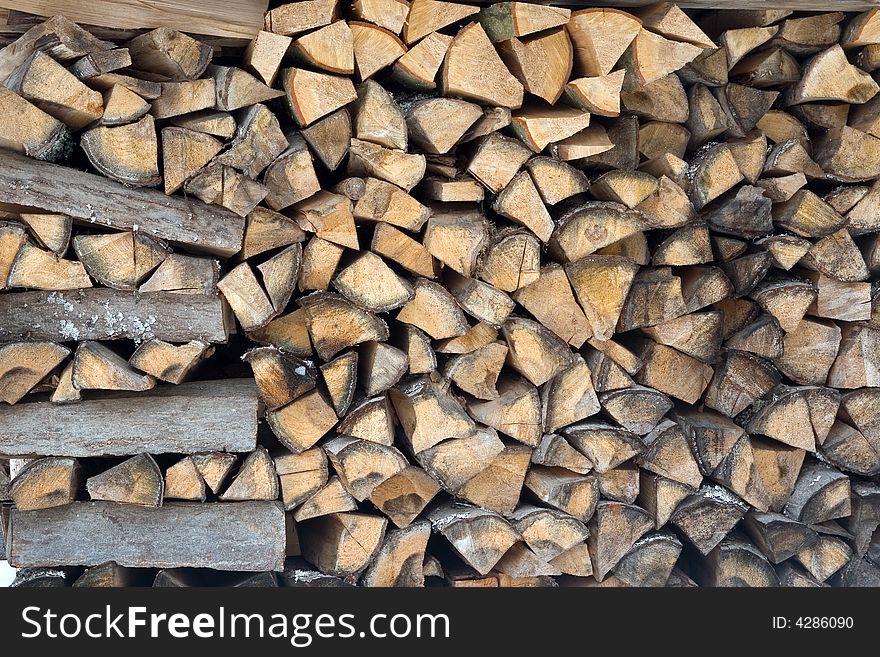 Photo of stacked firewood in storage until winter. Photo of stacked firewood in storage until winter.