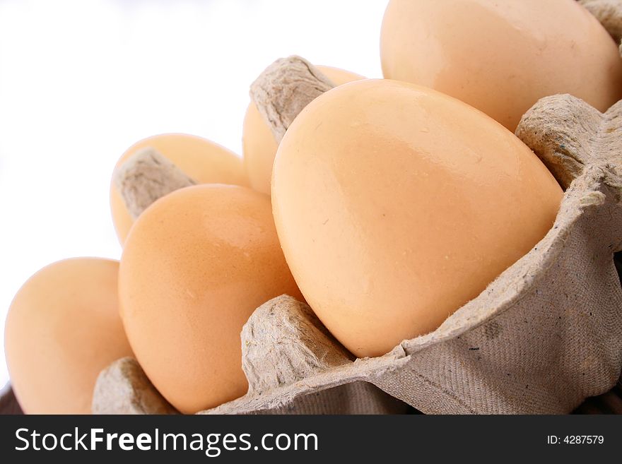 Brown eggs against a bright white background