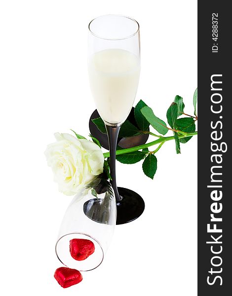 Two glasses with a rose and red hearts on a white background (isolated). Two glasses with a rose and red hearts on a white background (isolated)