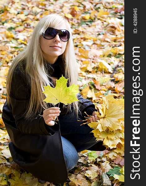 Blonde girl holding yellow leaf. Blonde girl holding yellow leaf.