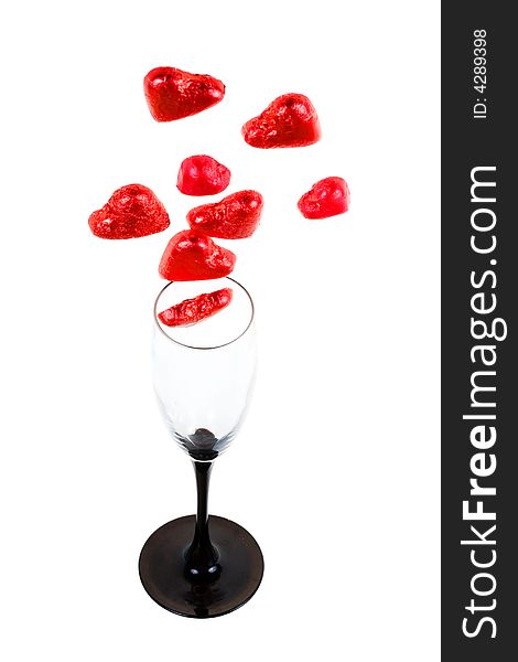 Glass and red hearts on a white background (isolated). Glass and red hearts on a white background (isolated)