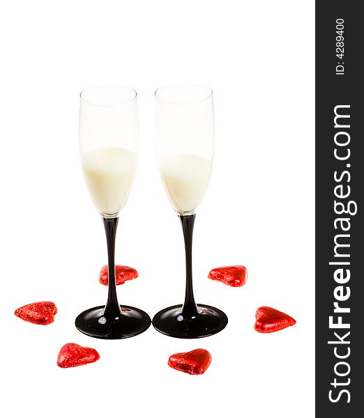 Two glasses with red hearts on a white background (isolated). Two glasses with red hearts on a white background (isolated)