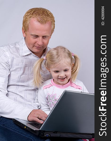 Father and daughter using laptop