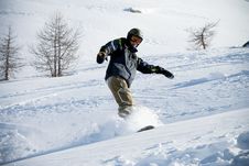 The Snowboarder Riding On A Virgin Soil Stock Photo The Snowboarder Riding On A Virgin Soil Stock Photo