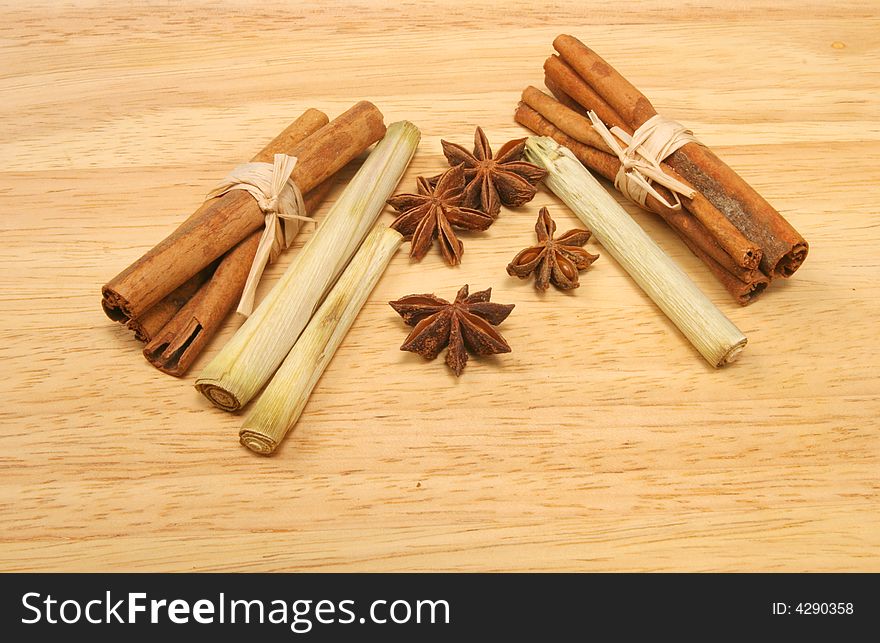 Cinnamon sticks star anise and lemon grass on a wooden background. Cinnamon sticks star anise and lemon grass on a wooden background