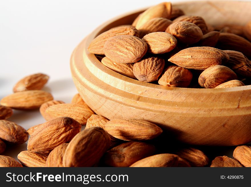 a heap of almonds in wooden container