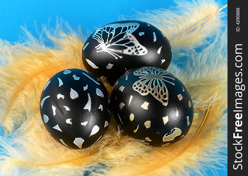 Easter egg with yellow feathers, hand-painted. Easter egg with yellow feathers, hand-painted