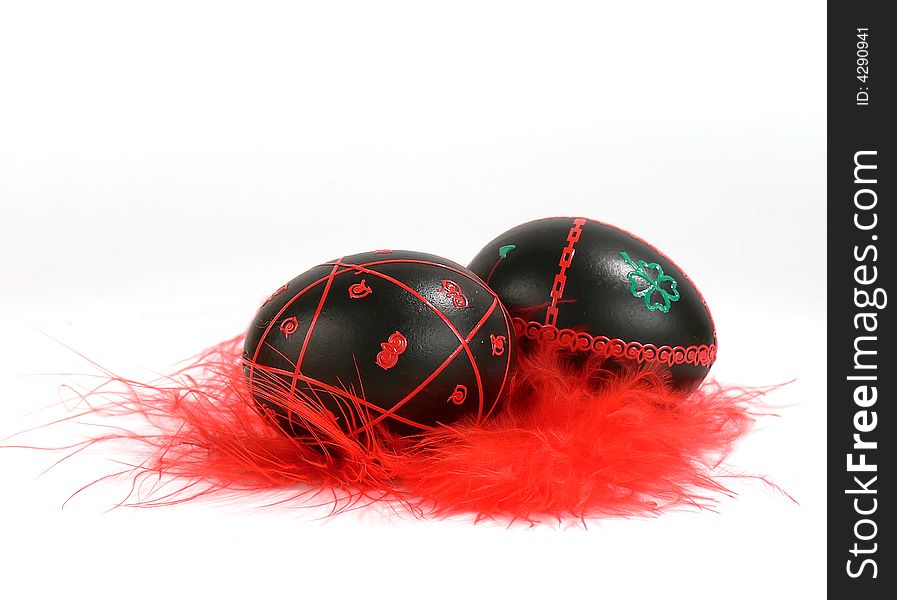 Easter eggs with red feathers, hand-painted