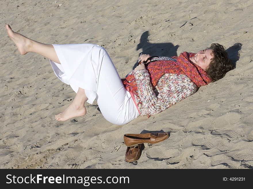 Happy woman relaxing outside on the beach, spring is coming