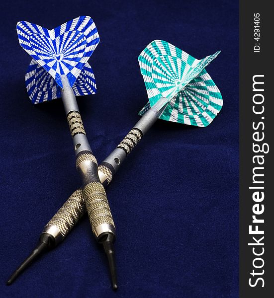 Blue and green darts on blue background. Blue and green darts on blue background