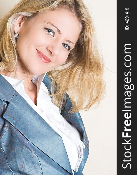Beautiful Blond Adult Female model wearing a blue jacket