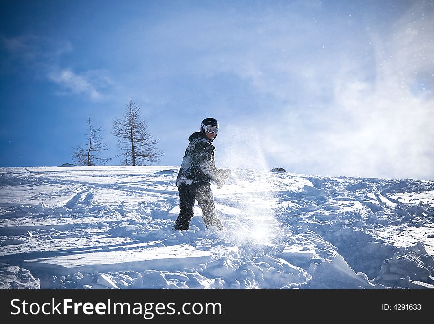 The snowboarder riding on a virgin soil