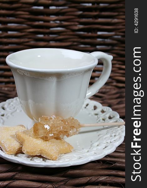 Cup and saucer with star shaped biscuits. Cup and saucer with star shaped biscuits
