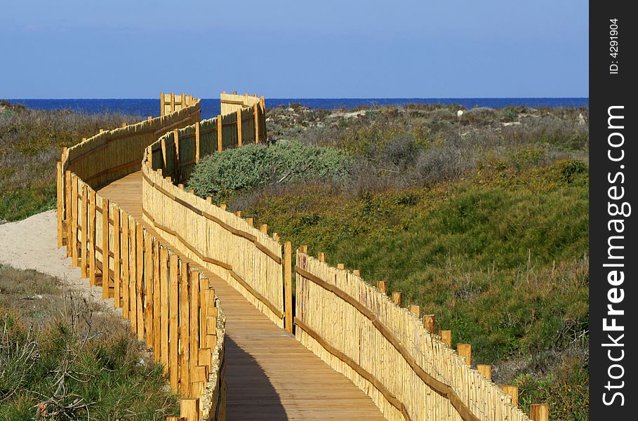 A quiet pathway leads to a beautiful beach. Sardinia beach.