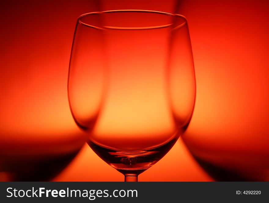 Three empty glasses on red background