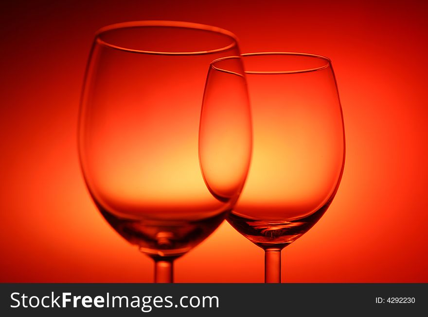 Two empty glasses on red background