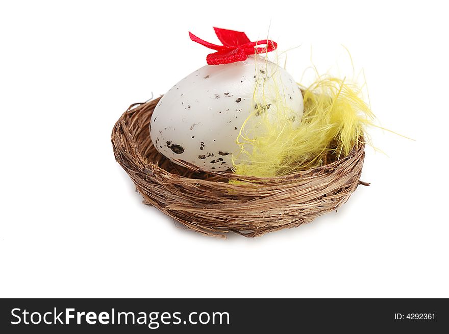 Nest with  decorative egg inside on white background. Nest with  decorative egg inside on white background