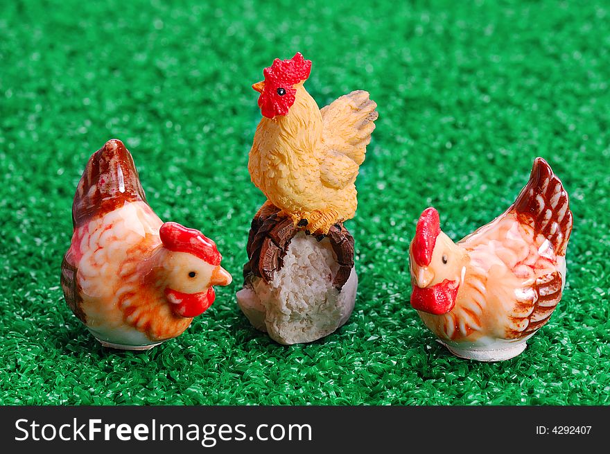 Easter decoration - two hens and rooster on green