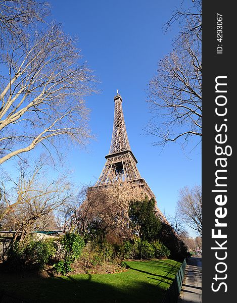 The Eiffel Tower is an iron tower built on the Champ de Mars beside the River Seine in Paris. The tower has become a global icon of France and is one of the most recognizable structures in the world.