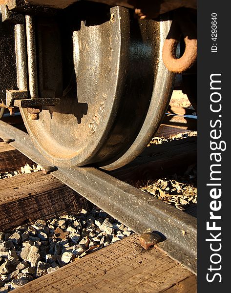 A close up of a wheel on the train tracks. A close up of a wheel on the train tracks.