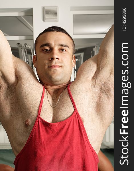 Portrait of a muscular man in fitness center.