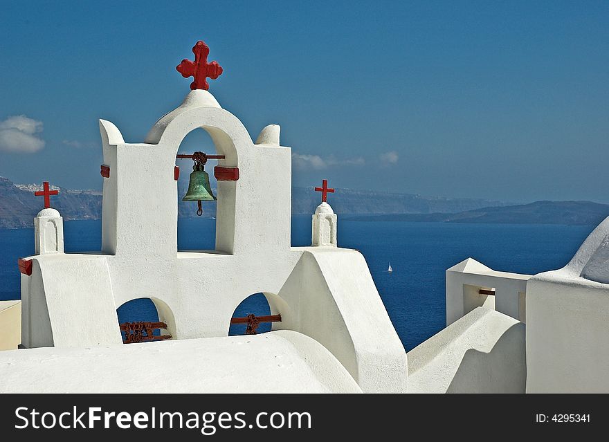 A whitewashed, belltower overlooking the Aegean sea. A whitewashed, belltower overlooking the Aegean sea