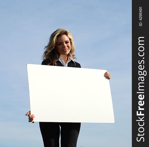 Portrait of a confident and successful businesswoman holding blank board. Portrait of a confident and successful businesswoman holding blank board