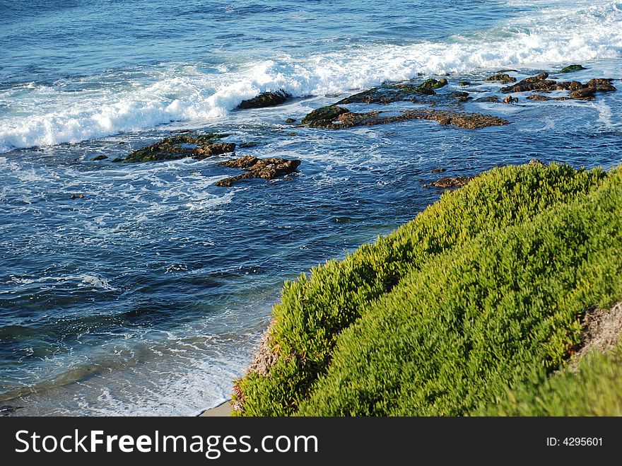 Beautiful landscape with blue waves crashing to the shore. Beautiful landscape with blue waves crashing to the shore